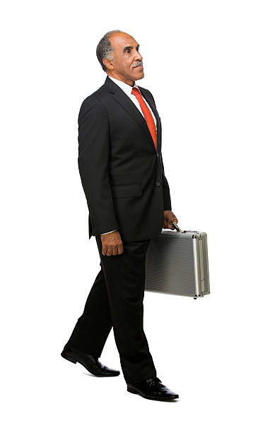 istock Senior latin executive carrying briefcase 457074633