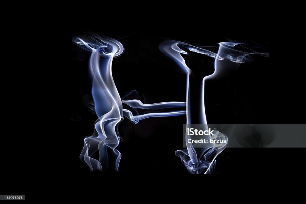 Big smoke letter H Big letter H done whit blue smoke. Isolated on black background. Abstract Stock Photo
