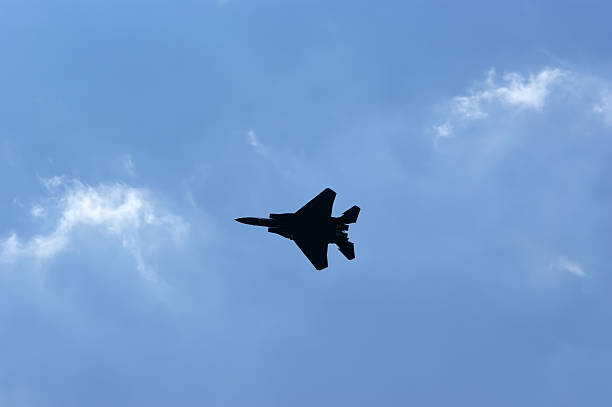 istock Flight of modern combat fighters on the sky background 457075949