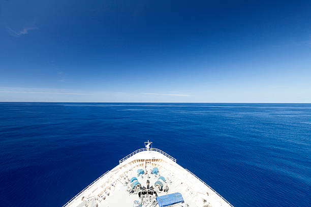 Wide Blue Ocean Luxury ship sailing on calm waters ships bow photos stock pictures, royalty-free photos & images