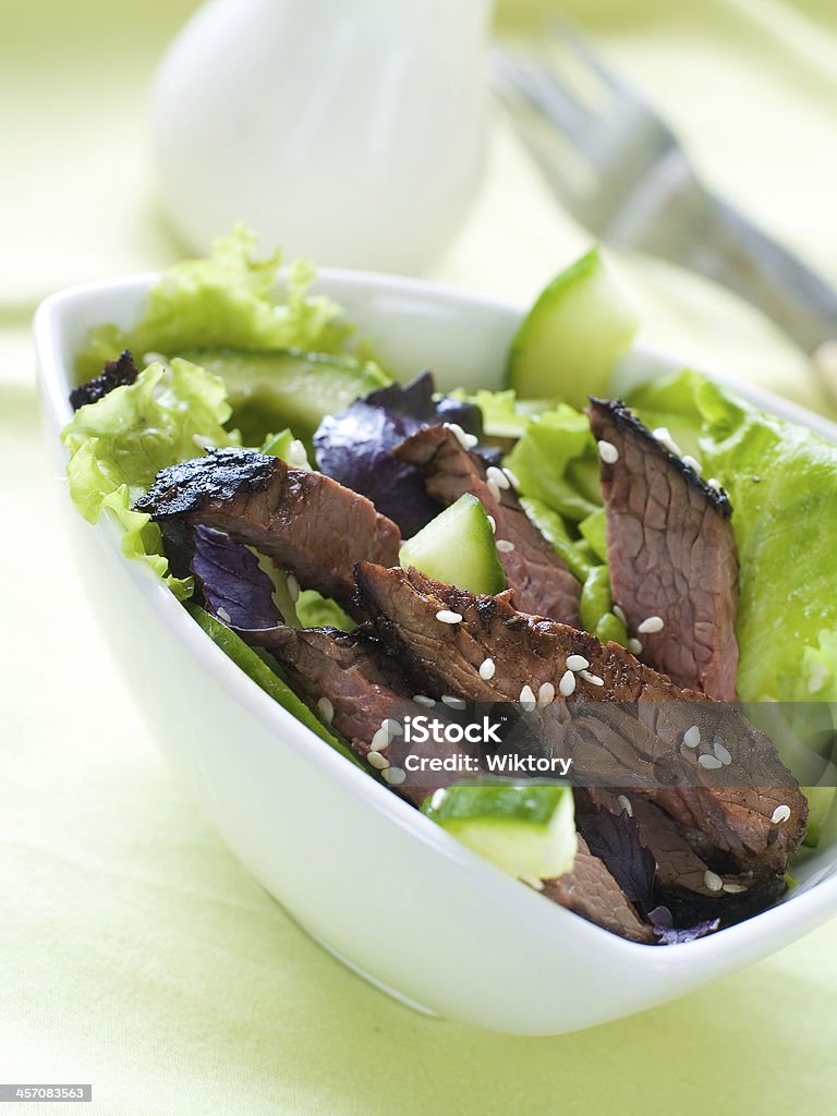 Ostrich (beef) salad Ostrich (beef) salad with lettuce and cucumber, selective focus Appetizer Stock Photo