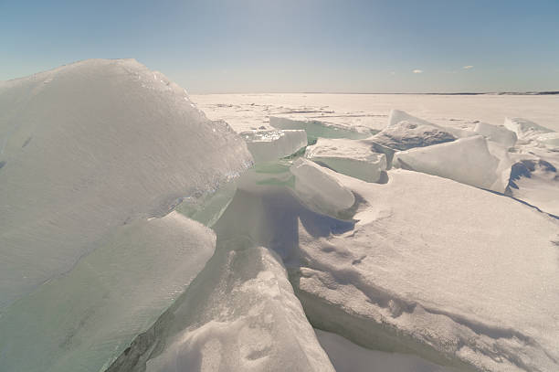 istock Snow, hummocks on snow-covered ice of lake. 457084319