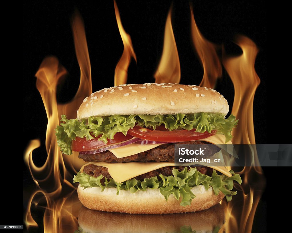 hamburger Delicious hamburger with fire on black background Beef Stock Photo