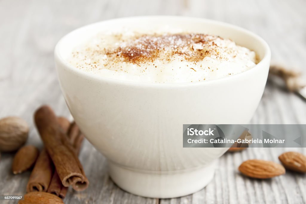 Rice pudding with cinnamon powder creamy rice pudding with cinnamon powder,cinnamon sticks and almonds Rice Pudding Stock Photo