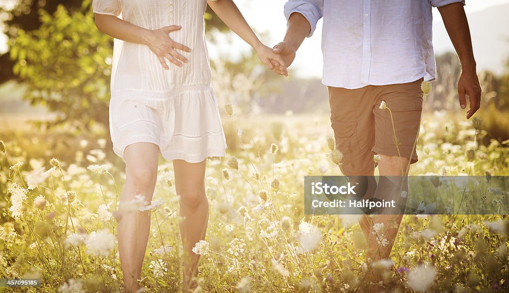 Pregnant couple Happy and young pregnant couple hugging in nature Abdomen Stock Photo