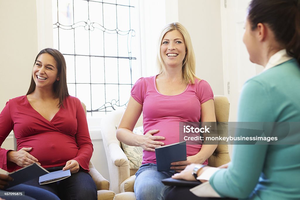 Pregnant Women Meeting At Ante Natal Class Pregnant Women Smiling In Meeting At Ante Natal Class 20-29 Years Stock Photo