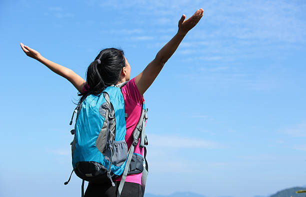 istock hiking woman with her arms raised mountain peak 457096809