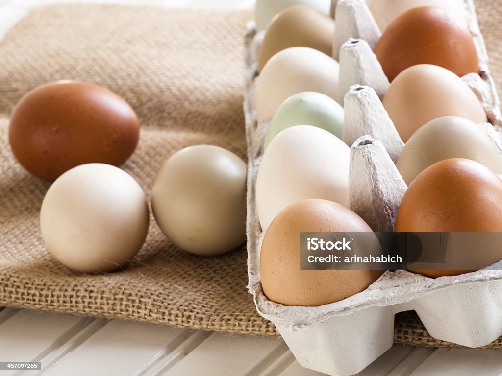 Eggs Fresh multi-color farm eggs on the table. Agriculture Stock Photo