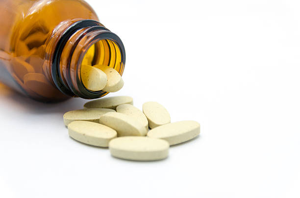 istock medicine bottle and pills 457099107