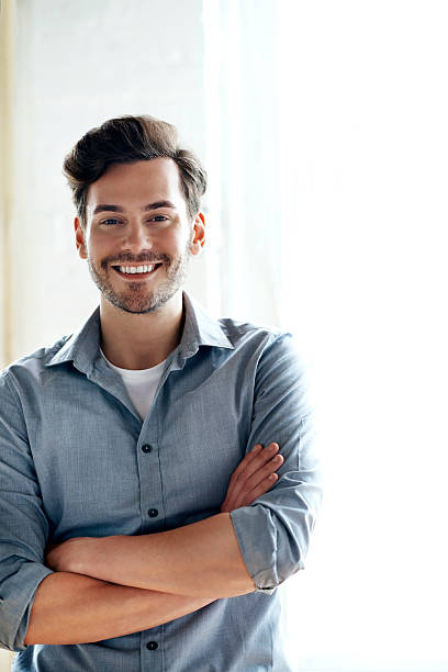 Portrait of smiling man Portrait of young, smiling and confident man 25 year old man portrait stock pictures, royalty-free photos & images