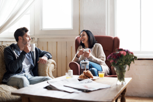 Couple drinking coffee together in their cozy loft apartment
