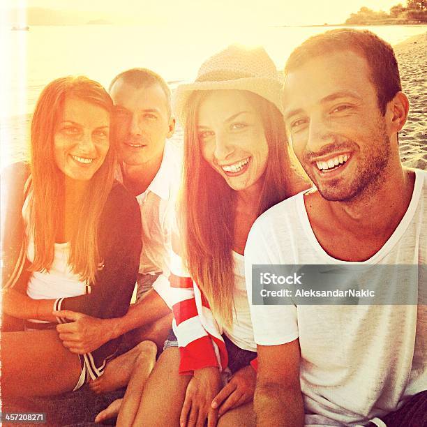 Smiling Friends On A Beach Stock Photo - Download Image Now - 20-29 Years, Adult, Adults Only