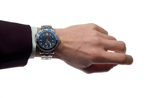 istock Businessperson displaying a silver and blue wristwatch 457214449