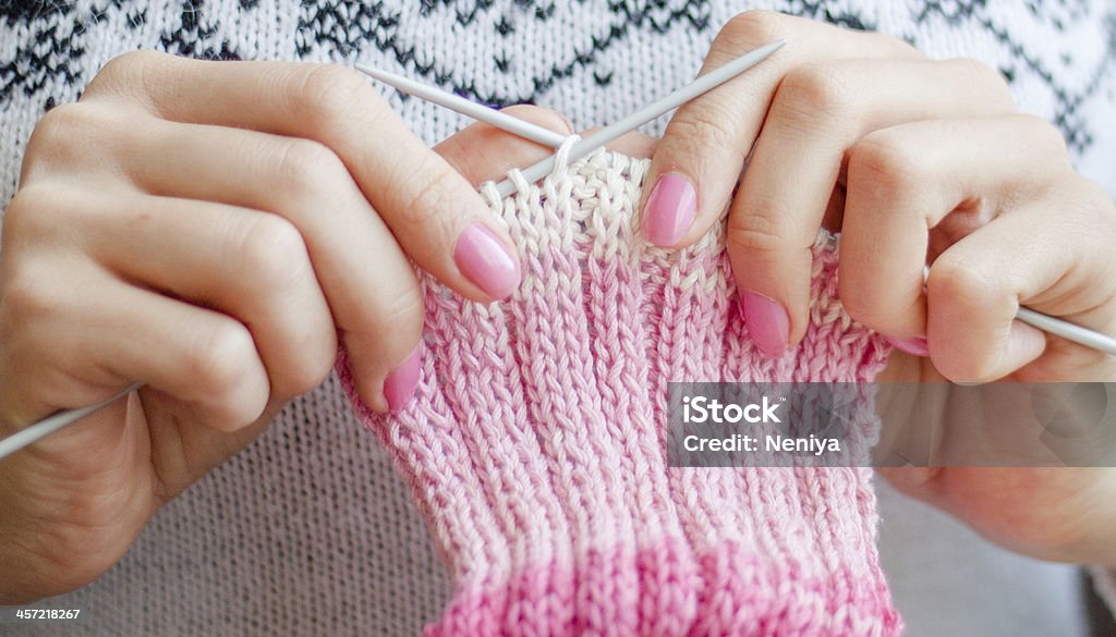 Knitting Knitting hands with knitted piece of scarf and knitting needles Activity Stock Photo