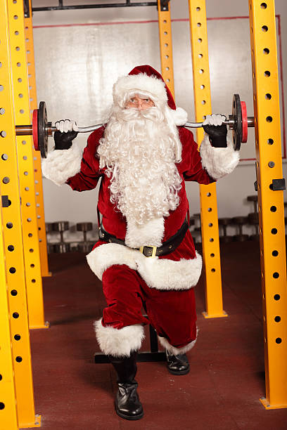 istock Santa Claus lifting weights in gym - training before Christmas 457281157