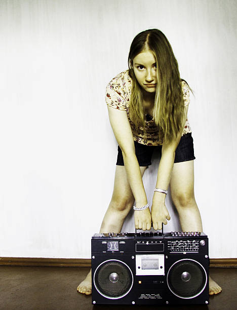 istock Young woman and old tape recorder 457305339