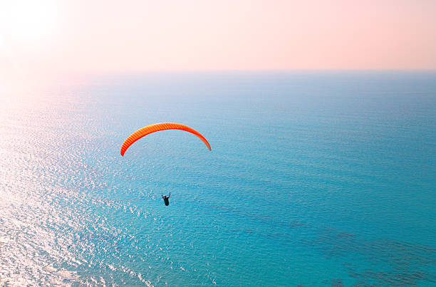 istock Paraglider soaring over the sea 457328763