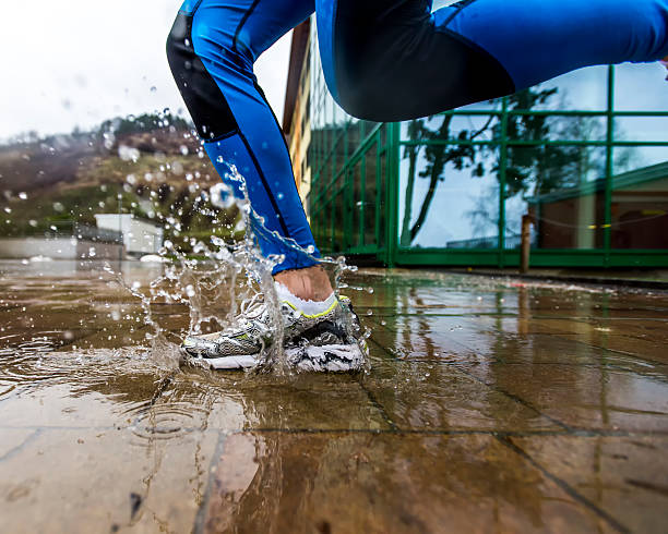 istock Sport shoes making big water splash running 457328919