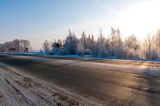 istock Winter road surrounded by snow-covered forest in Siberia 457329055