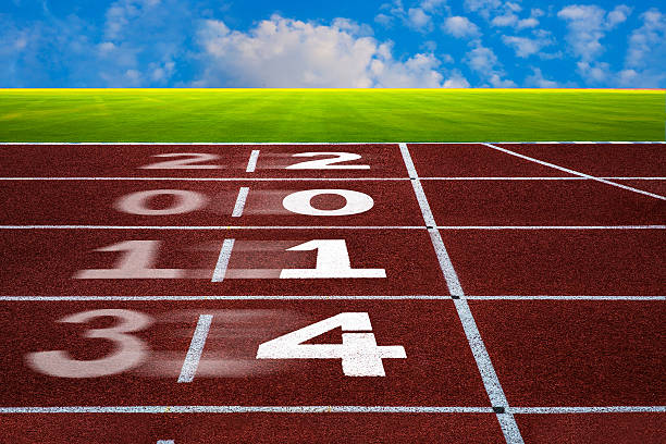 istock New Year 2014 on running track concept with blue sky. 457330775