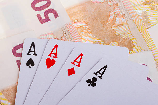 istock Four aces on top of some 50 euro banknotes 457330781