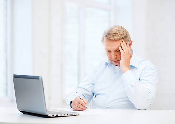 istock old man filling a form at home 457330805