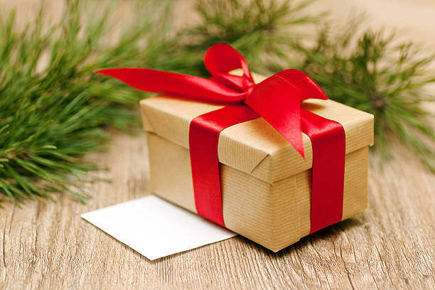 istock beige gift box with red ribbon in soft focus 457340287