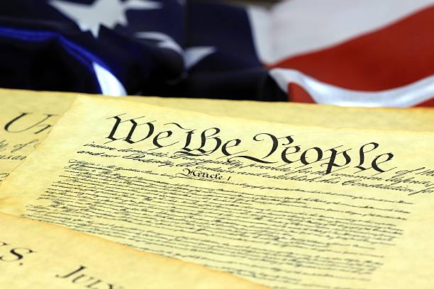 istock American Constitution and US Flag 457341523
