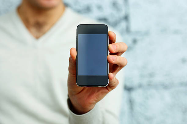 istock image of a male hand showing smartphone display 457343315