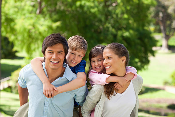 istock Smiling children are getting piggybacks from their parents 457347297