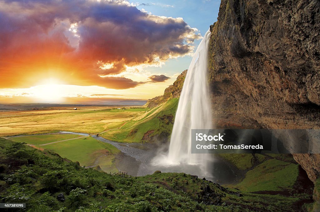 Waterfall, Iceland - Seljalandsfoss Seljalandsfoss is one of the most beautiful waterfalls on the Iceland. It is located on the South of the island. With a rainbow. Waterfall Stock Photo