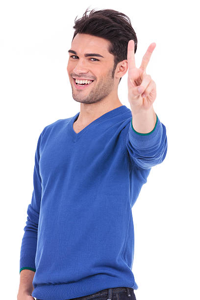 istock smiling young man making the victory sign 457388505