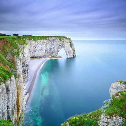 Etretat, la Manneporte natural rock arch wonder, cliff and beach. Long exposure photography. Normandy, France.