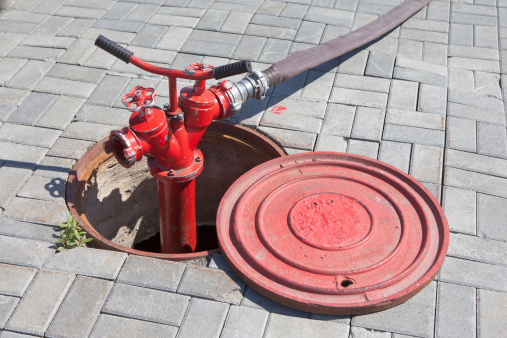 Fire hydrant red, connected to the water supply