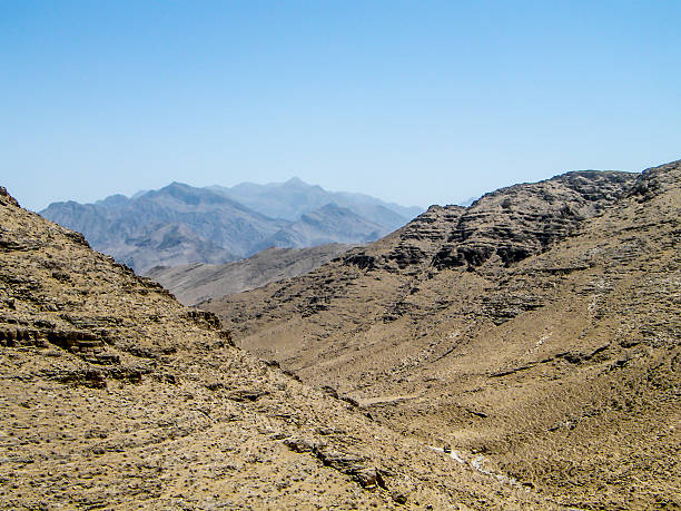 Afghanistan war mountain trail Small vehicle convoy amongst vast Helmand mountains hindu kush range stock pictures, royalty-free photos & images