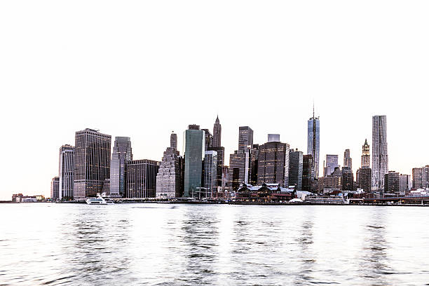 View of Lower Manhattan skyscrapers and Ground Zero at dusk.