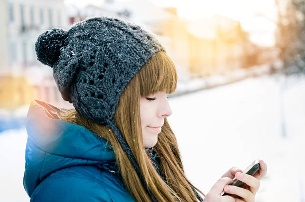 istock girl using smart phone outdoors 457393075