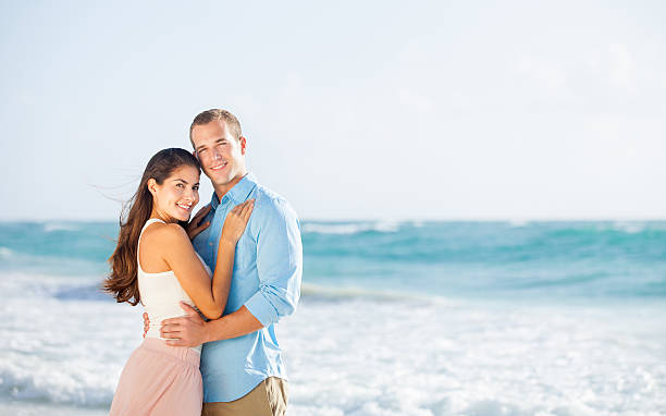 istock Happy couple facing each other at the beach 457393305