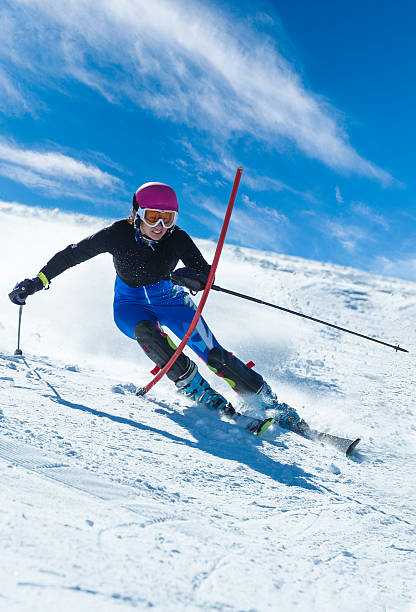 istock Portrait of young woman practicing slalom skiing 457393633