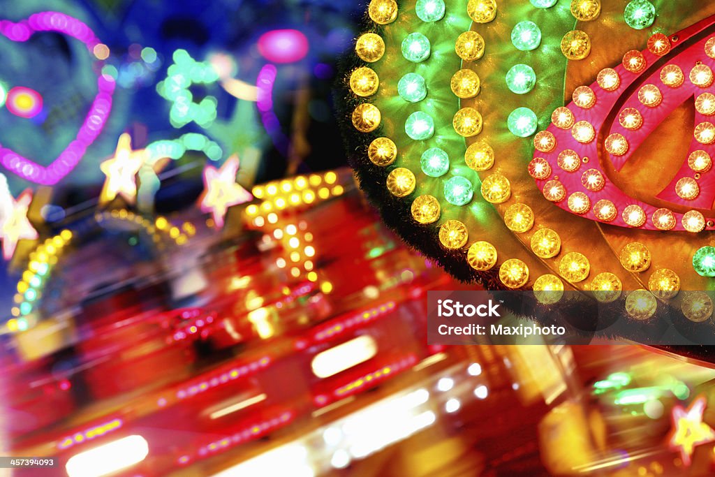 Colorful amusement park funfair lighting with vibrant light bulbs background Happy funfair lighting with vibrant color and blinking neons Traveling Carnival Stock Photo
