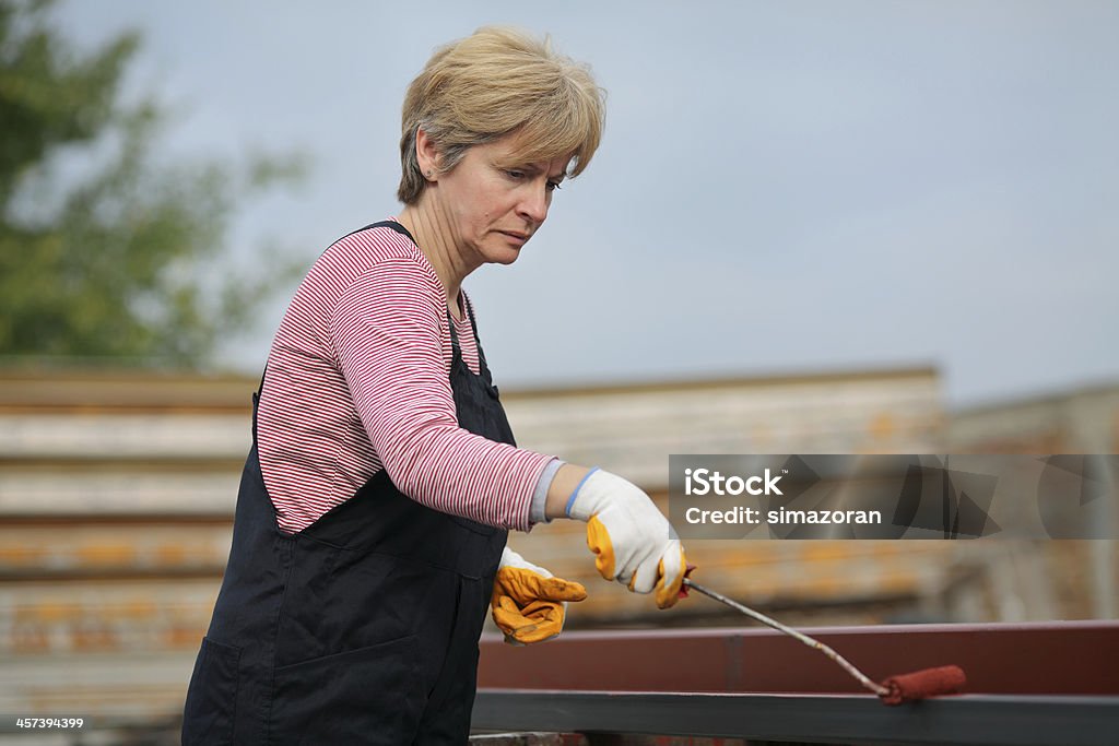 Female worker Serious female worker painting tube with paintroller, real people selective focus and no retouching 40-49 Years Stock Photo