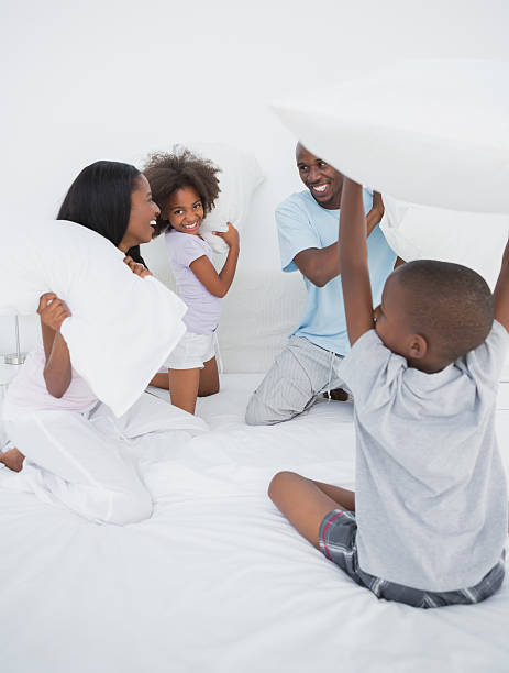 istock Laughing family having a pillow fight 457401969