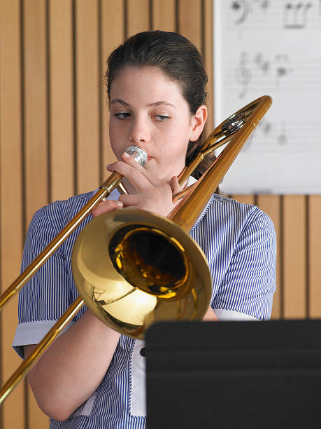 istock Girl Playing Trombone In Music Class 457403875