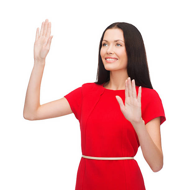 istock woman in red dress working with virtual screen 457407279