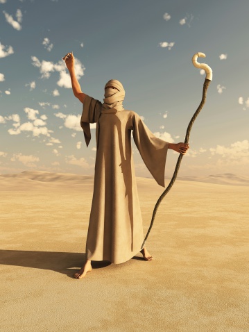 Robed desert nomad sorcerer or magician with magical staff, 3d digitallly rendered illustration.