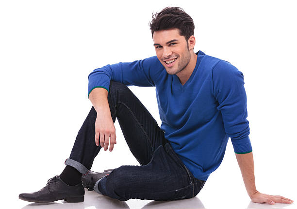 istock relaxed casual man sitting on white background 457410975