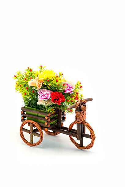 istock Wooden bicycle with colorful flowers on white 457416795