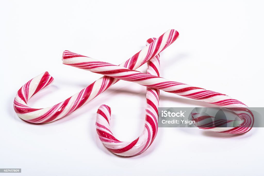 three twisted red and white candy canes three twisted red and white candy canes on a white background Candy Stock Photo
