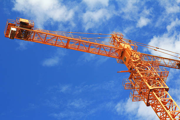 istock crane and blue sky on building site 457418989