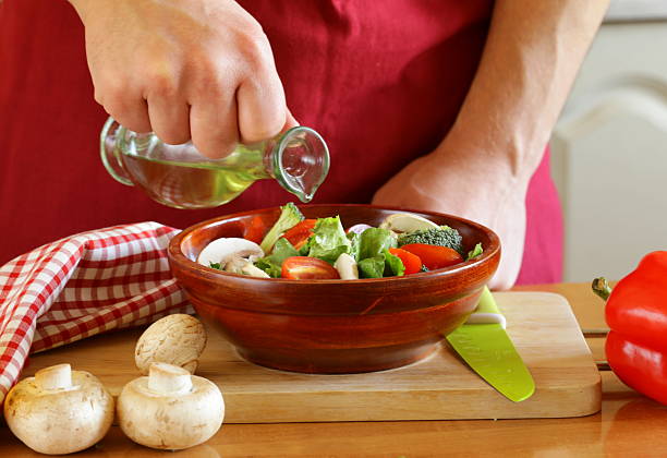 istock hand man chef cooking vegetable salad 457420189